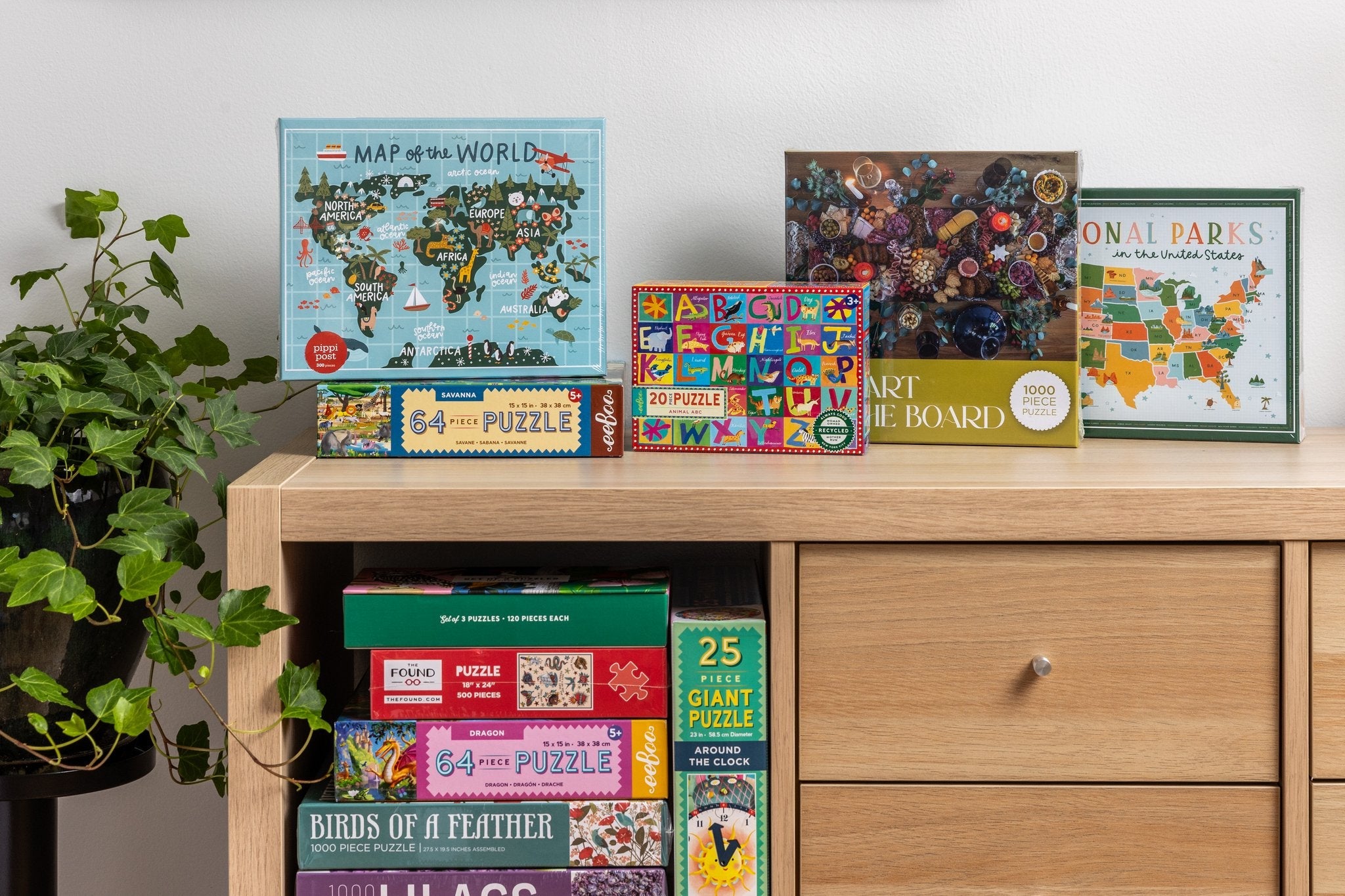 A pine cabinet is stuffed full with puzzles of all shapes and sizes, some for adults, some for kids.