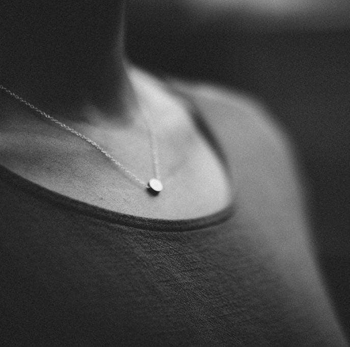 Simple brass dot necklace on sterling chain