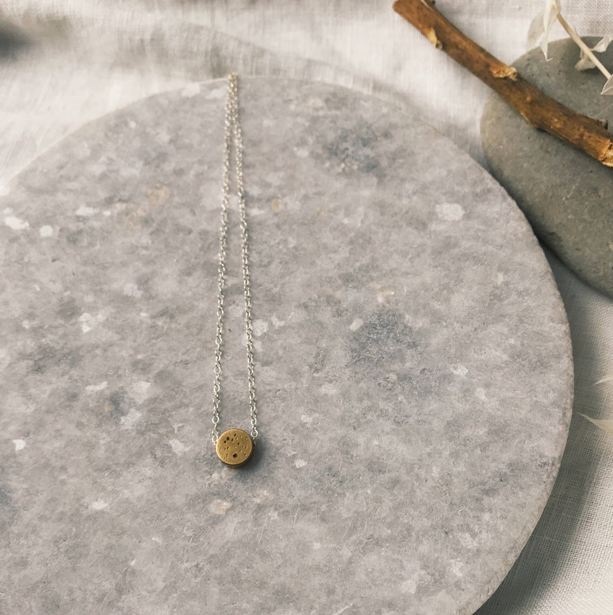 Simple brass dot necklace on sterling chain